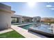 Luxury pool and spa with a waterfall feature in a modern backyard setting at 12808 E Harper Dr, Scottsdale, AZ 85255