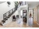 Two-story entryway with staircase and decorative plants at 144 E Boca Raton Rd, Phoenix, AZ 85022