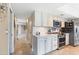 Bright kitchen with white cabinets and a view into hallway at 144 E Boca Raton Rd, Phoenix, AZ 85022