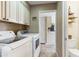 Laundry room with washer, dryer, and built-in cabinets at 144 E Boca Raton Rd, Phoenix, AZ 85022