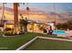 Backyard view with pool, fire pit, and beautiful sunset at 144 E Boca Raton Rd, Phoenix, AZ 85022