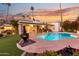 Dramatic sunset view of the backyard, pool, and fire pit at 144 E Boca Raton Rd, Phoenix, AZ 85022