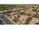 Aerial view of single story home with solar panels and desert landscaping at 1620 E Azafran Trl, Queen Creek, AZ 85140