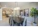 Elegant dining room with dark wood table and modern light fixture at 1620 E Azafran Trl, Queen Creek, AZ 85140