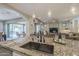 Granite kitchen island with sink and wine glass holder at 1620 E Azafran Trl, Queen Creek, AZ 85140