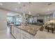 Kitchen island with granite countertop and seating area at 1620 E Azafran Trl, Queen Creek, AZ 85140