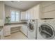 Laundry room with built-in cabinets, washer, and dryer at 1620 E Azafran Trl, Queen Creek, AZ 85140