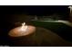 Night view of backyard fire pit and pool at 2415 W Weatherby Way, Chandler, AZ 85286