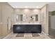 Modern bathroom boasts double vanity with dark cabinetry and quartz countertops at 2415 W Weatherby Way, Chandler, AZ 85286