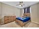 Bedroom with wood bed frame and ceiling fan at 2415 W Weatherby Way, Chandler, AZ 85286