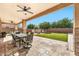 Covered patio with table and chairs, adjacent to the pool at 2415 W Weatherby Way, Chandler, AZ 85286