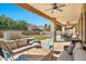 Covered patio with seating area, overlooking a grassy backyard at 2415 W Weatherby Way, Chandler, AZ 85286