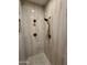 Walk-in shower with marble tile and rain shower head at 2415 W Weatherby Way, Chandler, AZ 85286