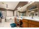 Elegant bathroom with double sinks, a large soaking tub, and a walk-in shower at 3121 S Verde Cir, Mesa, AZ 85212