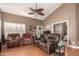 Relaxing living room with comfortable reclining furniture and a ceiling fan at 3121 S Verde Cir, Mesa, AZ 85212