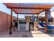 Outdoor kitchen with built-in grill and mini-fridge at 3121 S Verde Cir, Mesa, AZ 85212