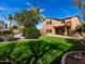 Two-story house with grassy backyard, pool, and mature trees at 319 E Palomino Way, San Tan Valley, AZ 85143