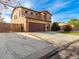 Two-story house with a wooden fence and a large driveway at 319 E Palomino Way, San Tan Valley, AZ 85143