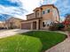 Two-story house with artificial turf and a nicely landscaped front yard at 319 E Palomino Way, San Tan Valley, AZ 85143