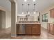 Kitchen island with sink, dishwasher, and cabinets at 319 E Palomino Way, San Tan Valley, AZ 85143