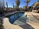 Kidney shaped pool with surrounding patio and landscaping at 319 E Palomino Way, San Tan Valley, AZ 85143