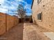 Side yard with dirt, block wall, and gated access at 319 E Palomino Way, San Tan Valley, AZ 85143