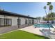 Open backyard patio with an inviting pool and well-maintained lawn at 342 E Orangewood Ave, Phoenix, AZ 85020