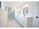 Modern bathroom with double vanity, large mirror and glass shower at 342 E Orangewood Ave, Phoenix, AZ 85020