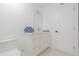 Clean bathroom with a white vanity, a countertop with towels, a mirror, and a toilet at 342 E Orangewood Ave, Phoenix, AZ 85020