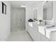 Bright bathroom with double sinks, modern fixtures, and a tiled shower at 342 E Orangewood Ave, Phoenix, AZ 85020