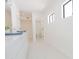 Clean, all-white bathroom with double sinks and modern fixtures at 342 E Orangewood Ave, Phoenix, AZ 85020