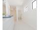 All-white bathroom with modern double sink vanity at 342 E Orangewood Ave, Phoenix, AZ 85020