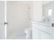 Modern white bathroom featuring a vanity with a shower and toilet at 342 E Orangewood Ave, Phoenix, AZ 85020