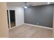 Bright bedroom with gray accent wall and hardwood floors at 342 E Orangewood Ave, Phoenix, AZ 85020