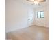 Bright bedroom featuring a modern ceiling fan, hardwood floors, and a window at 342 E Orangewood Ave, Phoenix, AZ 85020
