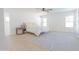 Bright bedroom featuring a light wood floor, a ceiling fan, and a stylish blue and white patterned rug at 342 E Orangewood Ave, Phoenix, AZ 85020