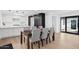 Dining area features modern lighting and flows into the updated kitchen with custom cabinetry at 342 E Orangewood Ave, Phoenix, AZ 85020