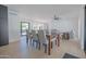 Spacious dining room features a modern table set, connecting living spaces, and ample natural light at 342 E Orangewood Ave, Phoenix, AZ 85020