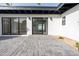 View of the front entrance with black framed glass doors and paver patio at 342 E Orangewood Ave, Phoenix, AZ 85020