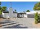 Modern home with white brick accents, dark trim, spacious gray brick driveway, and desert landscaping at 342 E Orangewood Ave, Phoenix, AZ 85020