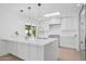 Beautiful white kitchen with custom cabinets, stainless steel appliances, and a skylight at 342 E Orangewood Ave, Phoenix, AZ 85020