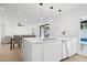 Contemporary kitchen island with sleek countertops, ample storage, and backyard views at 342 E Orangewood Ave, Phoenix, AZ 85020