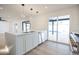 Modern kitchen island with white cabinets, quartz countertops and a stainless steel sink at 342 E Orangewood Ave, Phoenix, AZ 85020