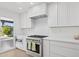 The modern kitchen features stainless steel appliances, white countertops, and stylish cabinets at 342 E Orangewood Ave, Phoenix, AZ 85020