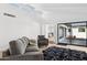 Spacious living room with high ceilings, gray furniture, hardwood floors, and a view to the kitchen and patio at 342 E Orangewood Ave, Phoenix, AZ 85020