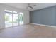 Open-concept living room featuring large windows, gray accent wall and beautiful wood flooring at 342 E Orangewood Ave, Phoenix, AZ 85020