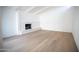 Living room with hardwood floors and a white brick fireplace at 342 E Orangewood Ave, Phoenix, AZ 85020