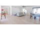 Open-concept living room featuring a dining table and a comfortable gray sofa at 342 E Orangewood Ave, Phoenix, AZ 85020