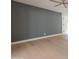 Spacious living room featuring a gray accent wall and light wood flooring at 342 E Orangewood Ave, Phoenix, AZ 85020