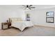 This primary bedroom offers a modern ceiling fan, an area rug, and two large windows at 342 E Orangewood Ave, Phoenix, AZ 85020